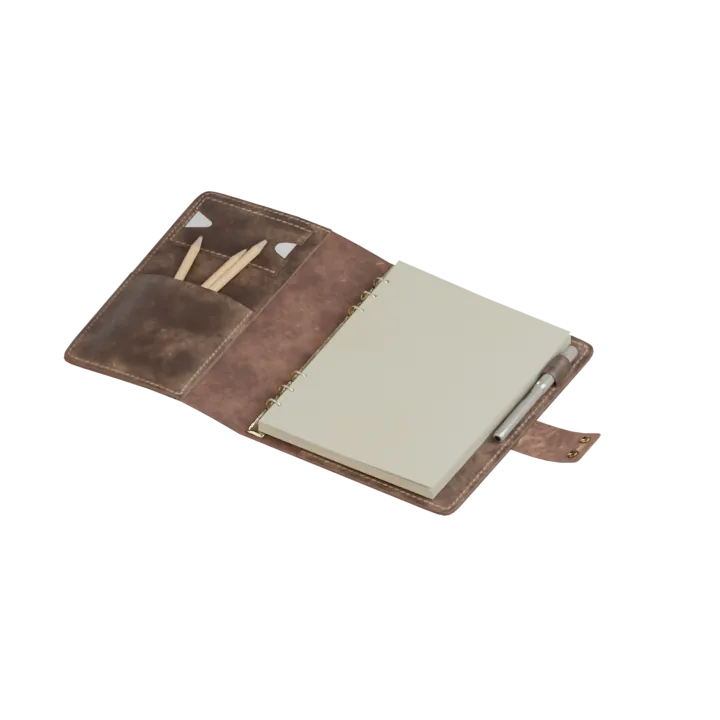 An open leather notebook with cream paper.